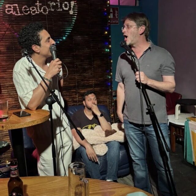 Two comedians on stage with microphones at a No Offense, But... show