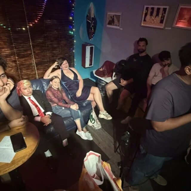 Comedian performing to a seated crowd at a No Offense, But... show